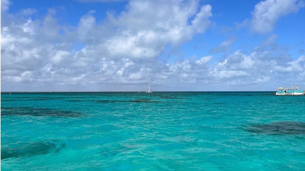 Turquoise water beneath a blue sky with scattered clouds at John Pennekamp Coral Reef State Park